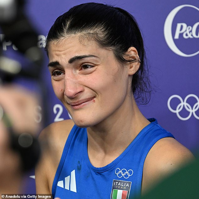 Italy's Angela Carini gets emotional after her loss in the preliminary round of the women's 66kg to Algerian Imane Khelif