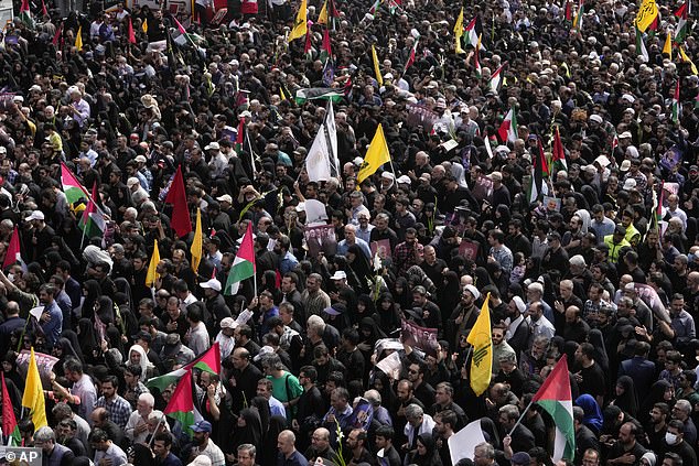 Iranians gather for the funeral ceremony of Hamas leader Ismail Haniyeh and his bodyguard who were killed in an assassination blamed on Israel, Wednesday, in Enqelab-e-Eslami