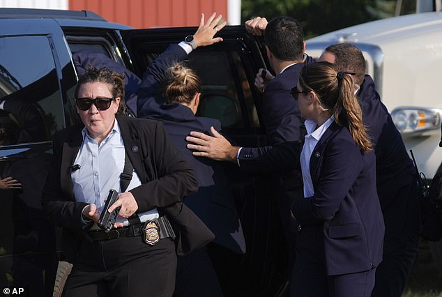 Republican presidential candidate and former President Donald Trump is spied on by US Secret Service agents at a campaign rally