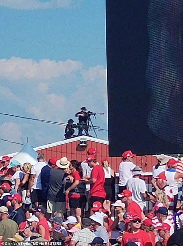 Snippers stand on a roof at the campaign rally of Republican presidential candidate and former US President Donald Trump