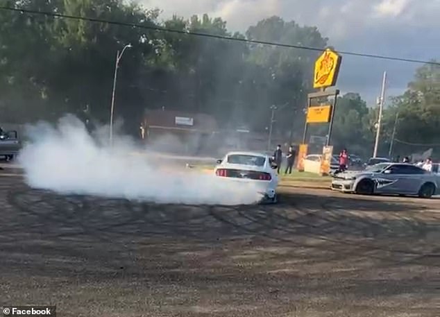 His video showed cars revving their engines and doing donuts in the middle of a busy street