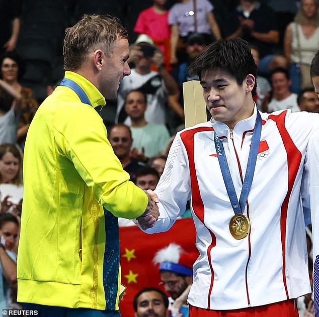 Chalmers was photographed shaking Pan's hand warmly after they received their medals