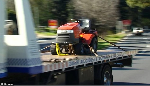 The photo shows a lawn mower being towed from Crawford's property on Tuesday