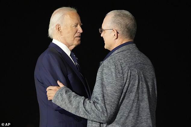 Joe Biden greets Paul Whelan, a 54-year-old former Marine who was sentenced to 16 years in prison in 2020 after being detained in Moscow two years earlier on suspicion of espionage.