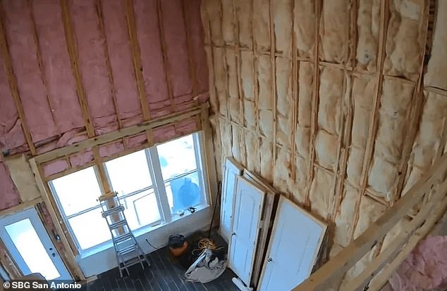 Plasterboard has been removed from the interior of the house, leaving exposed beams throughout