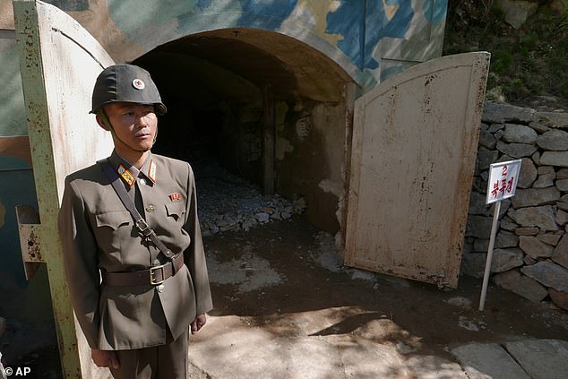 A guard stands at the entrance to the northern tunnel at the Punggye-ri nuclear test site, 2018