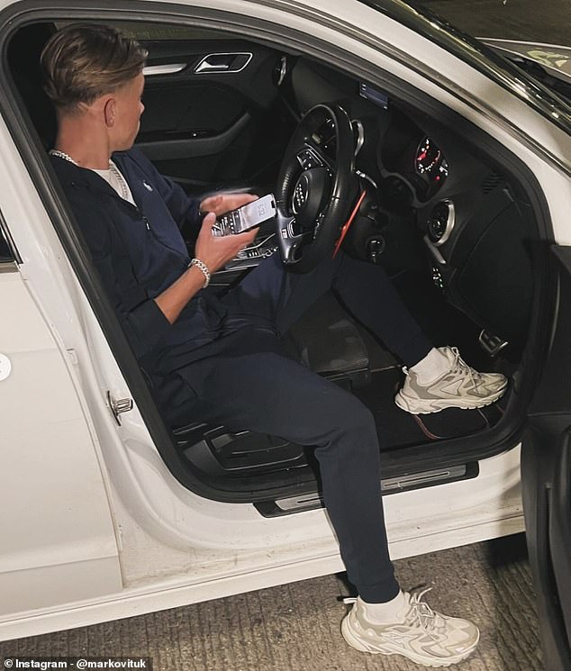 Marko pictured sitting in a car. At 16, he is currently not allowed to drive or buy alcohol, unlike his girlfriend who is 21