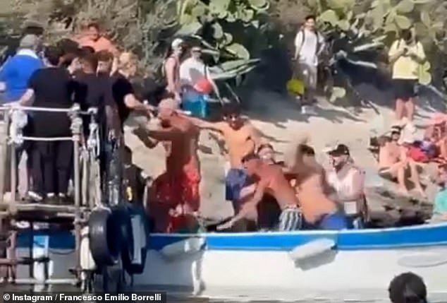 The fight quickly spread from the boat to the pier as the men in bathing suits kicked and punched each other