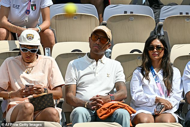 The Happy hitmaker looked smart and casual in a white Louis Vuitton polo shirt with a structured collar and a gold-tone branded brooch on the chest