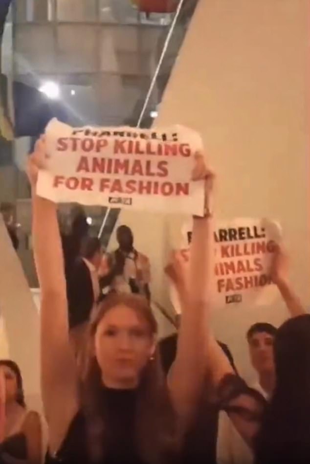 The party was disrupted by protesters from PETA (People for the Ethical Treatment of Animals) who waved signs asking him to stop using animals 'for fashion'