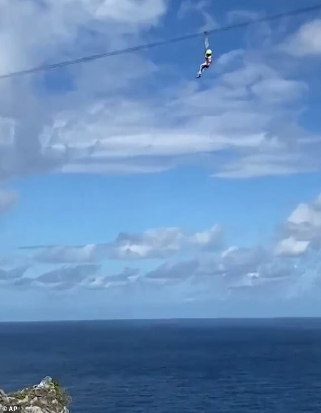 The girl's terrified and reportedly crying mother, along with several British tourists, watched in horror from the ground as the girl hung 100 metres above the ocean, as seen in the July video.