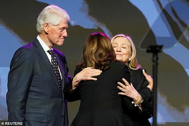 Former Secretary of State Hillary Clinton embraces Vice President Harris before speaking at the memorial service. Clinton was the first woman to run for president on a major party ticket in 2016.