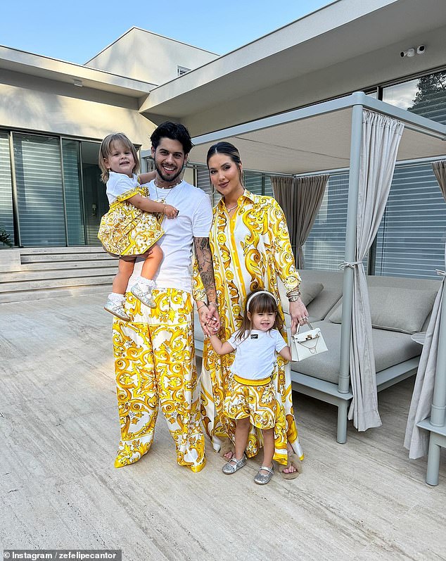 Zé Felipe carries his one-year-old daughter Maria Flor with his girlfriend Virginia Fonseca and their three-year-old daughter Maria Alice