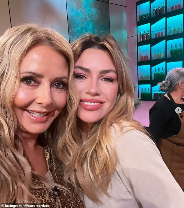 The TV star poses with model Abbey Clancy on the set of the ITV cooking show, which pairs celebrities with professionals to inspire them in the kitchen (pictured July 31)