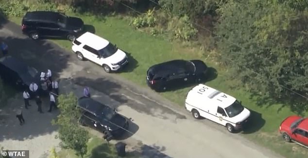 Police are pictured at the scene of Thursday morning's gruesome murder in Donegal Township, which is about 60 miles southeast of Pittsburgh