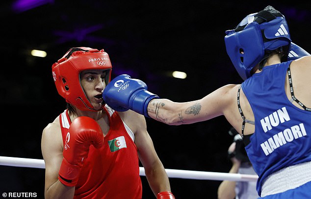 When Khelif entered the ring, she was greeted with loud cheers and celebrated Ronaldo-style, stiffening her knees and then standing with her arms up (pictured: The Bozes during the fight)