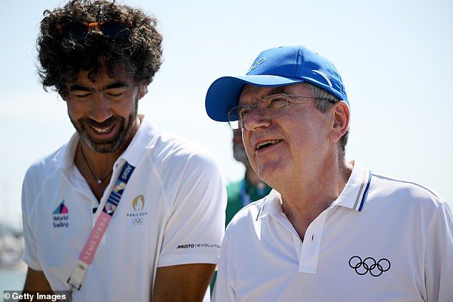 It was Thomas Bach (pictured right) who hung the sixth gold medal around Biles' neck, and he beamed the grin of a man on to something