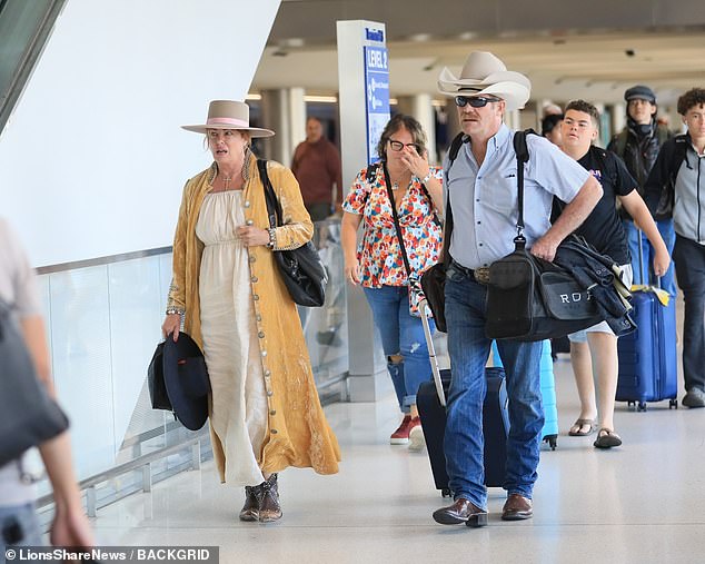 Weird Science star Kelly LeBrock, 64, looked like she hadn't aged a day as she left Los Angeles International Airport on Friday in a rare appearance