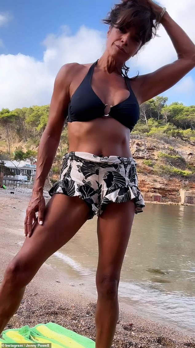 The TV presenter looked incredible as she showed off her washboard abs in a black halterneck bikini top