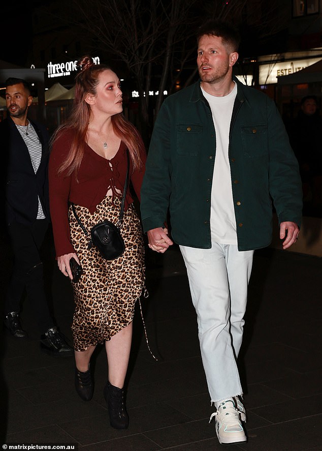 Melissa Rawson showed off her figure in a burgundy crop top and printed skirt as she arrived with husband Bryce Ruthven