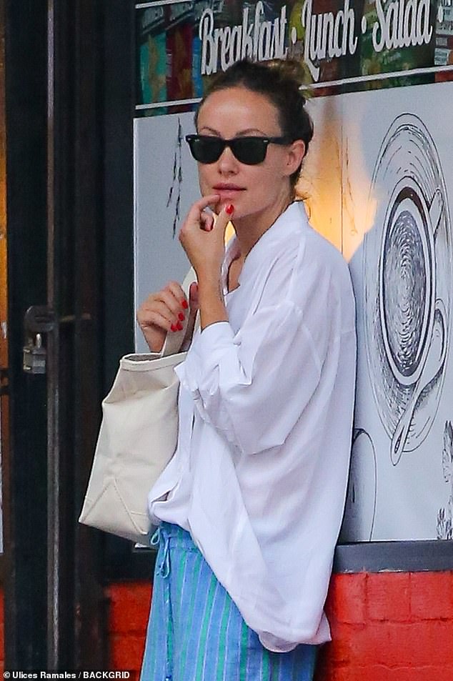 The makeup-free star looked flawless in black Ray-Ban sunglasses and her brown hair in a bun