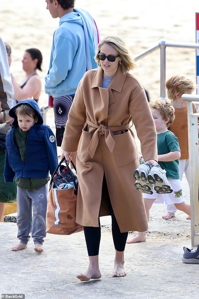 The couple appeared relaxed and happy as they watched sons Oscar and Henry play nearby