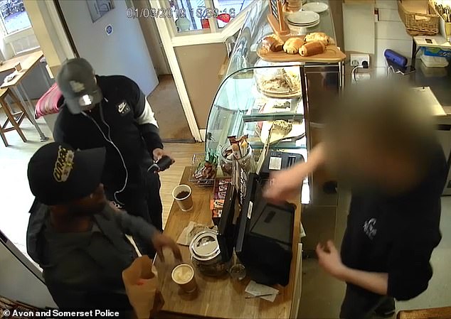 Pictured: Said-Baker and Said-Ahmed distract a worker at Café Revival in Bristol while stealing thousands of pounds