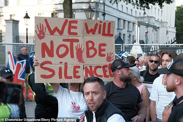 Far-right protesters arrived at Downing Street on Wednesday evening carrying signs reading: 'We will not be silenced'