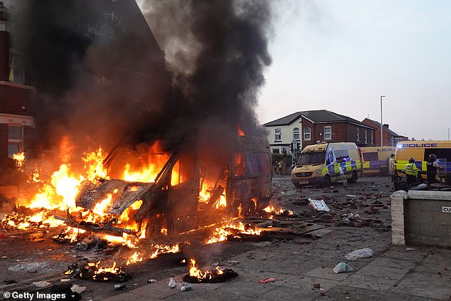 A burnt out police van at a mosque in Southport as shocking riots broke out on Tuesday