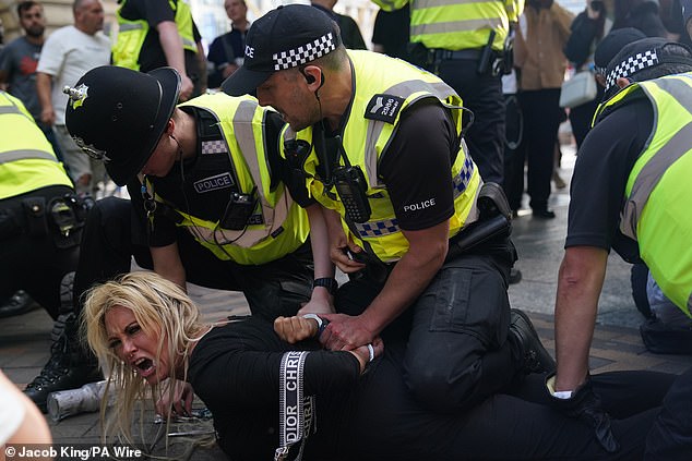 NOTTINGHAM: Police officers arrest a woman during a protest as she shouts her protest