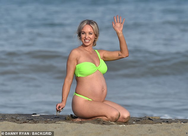 Jorgie showed off her growing baby bump on the beach in Spain on Saturday