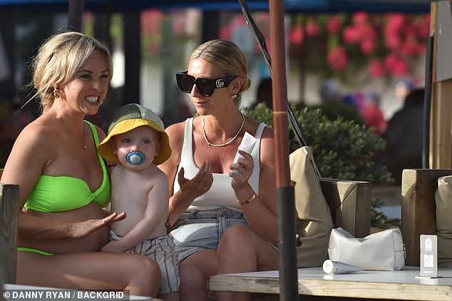 And later, Jorgie enjoyed a cuddle with her 21-month-old son Forest while chatting with a friend