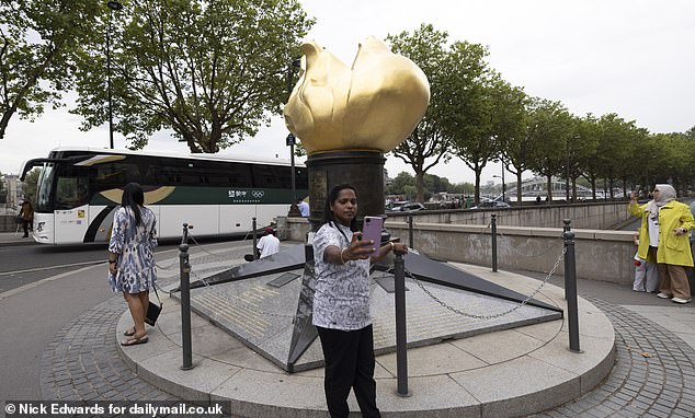 A woman takes a selfie at the Flame of Liberty. Although it is not officially designated as a memorial to Diana, its proximity to the scene of the tragedy has made it a natural place for mourners to pay their respects.