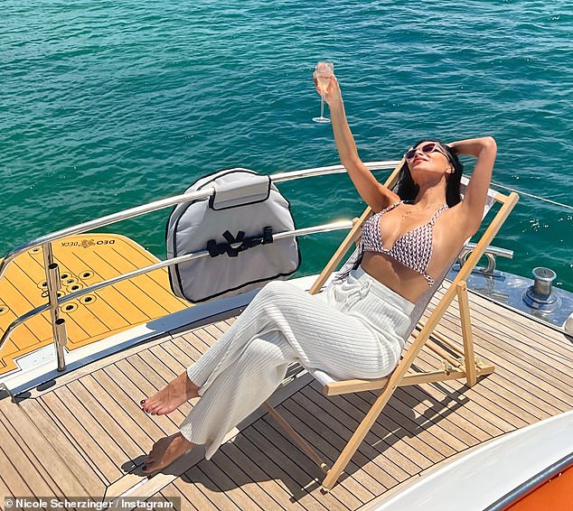 The Masked Singer judge later slipped into a stylish pair of white crochet pants as she sipped on a glass of bubbly while sitting in a lounge chair on the stern of the boat