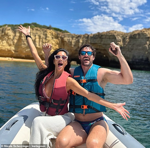 In another photo on the RIB, Nicole posed with her fiancé Thom Evans as they both donned life jackets