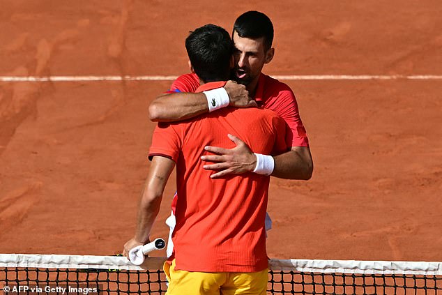 New Olympic champion Djokovic is pictured embracing Carlos Alcaraz after beating him 7-6 7-6.