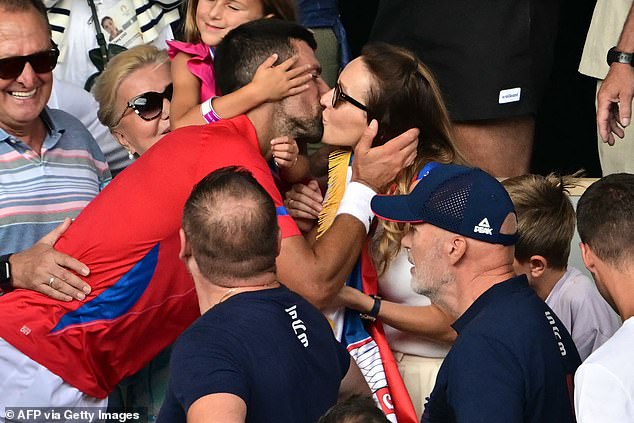 Djokovic pictured kissing his wife Jelena after winning a career Golden Slam on Sunday