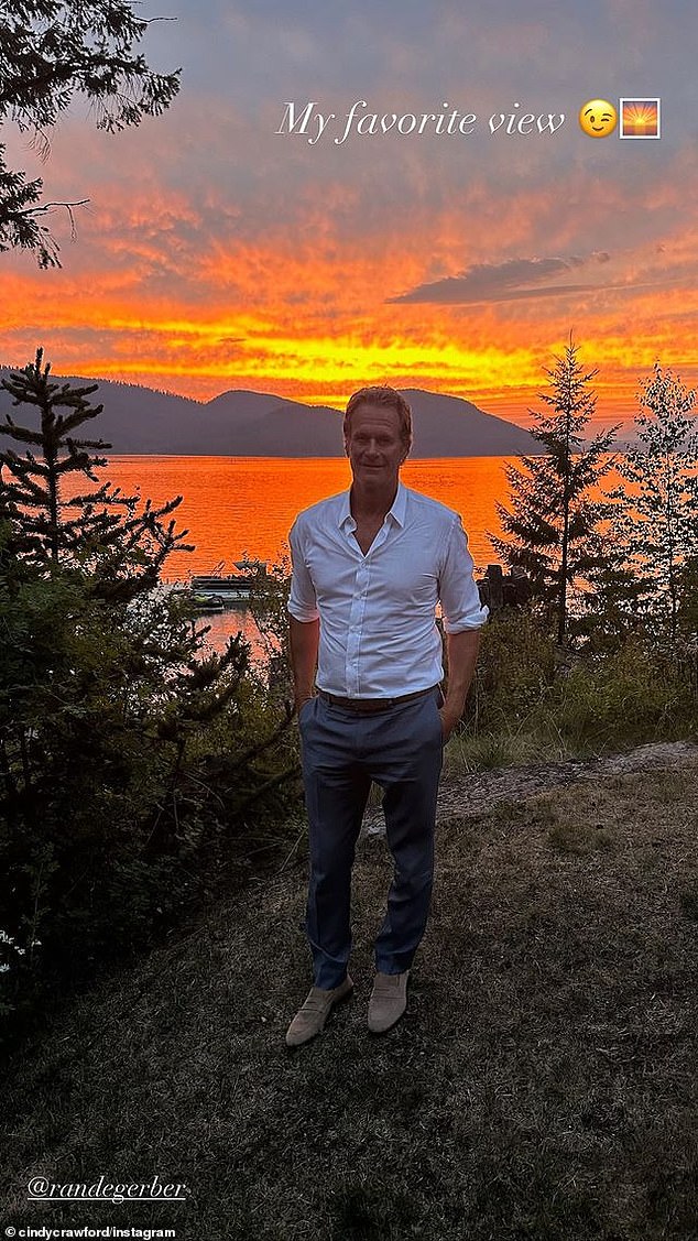 Another photo shows the Casamigos co-founder standing in front of the lake against a beautiful orange and yellow sunset. 