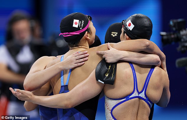 Rio Sharai, Satomi Suzuki, Mizuki Hirai and Rikako Ikee of Team Japan embrace after competing in the final of the women's 4x100m medley relay