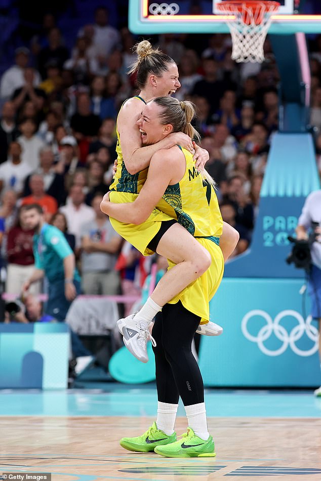 Whitcomb (left) and teammate Tess Madgen (right) were elated when the buzzer sounded and the green and gold emerged victorious with seven points.