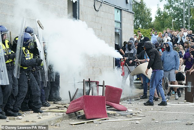 Protesters and police clash in Rotherham tonight as Malaysia becomes the first country to warn its citizens of the dangers of visiting Britain at this time.