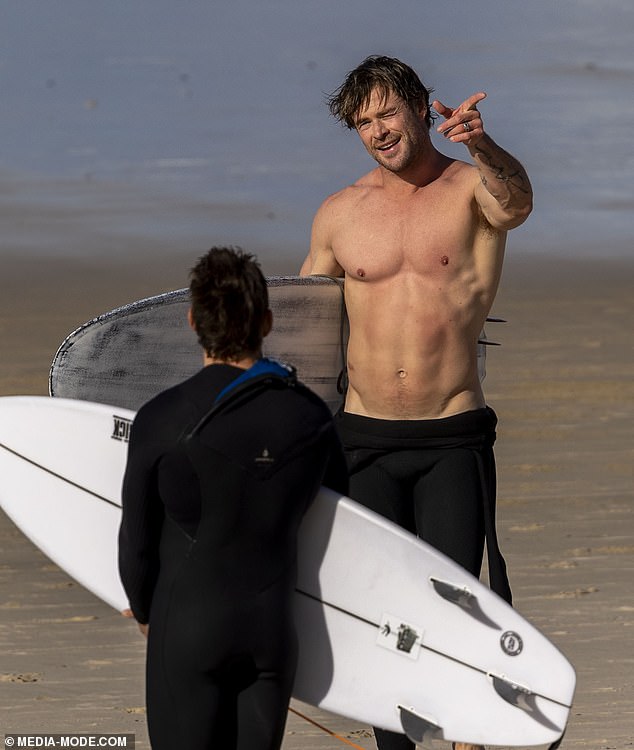 With his sandy blonde locks tousled as they blew in the wind, Chris wasn't shy about showing off his toned abs and muscular biceps