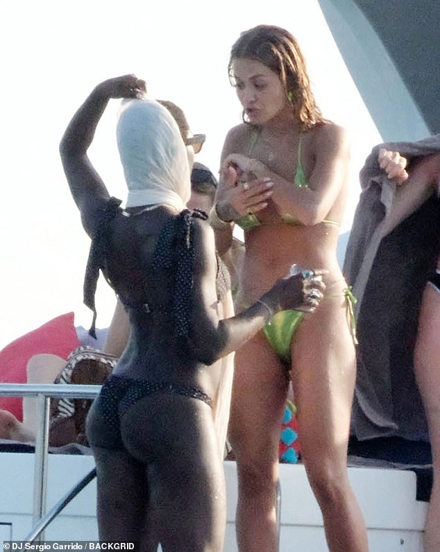 The 37-year-old actress showed off her stunning figure in a black bikini as she was spotted sipping a cocktail and chatting with pals on board the luxury liner, including Rita Ora