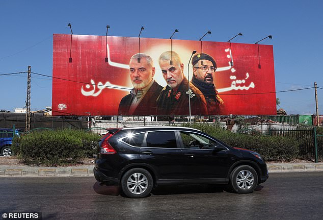 A car drives past a poster showing deceased Hamas leader Ismail Haniyeh, Iranian Quds Force top commander Qassem Soleimani and Hezbollah top commander Fuad Shukr in Beirut, Lebanon