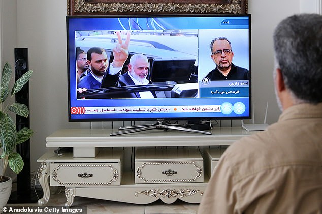 A man watches the news on TV after Hamas Political Bureau Chief Ismail Haniyeh was killed in an Israeli airstrike targeting his home in the Iranian capital Tehran, Iran on July 31, 2024.