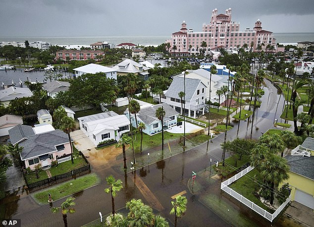 Flooding is seen near homes as The Don CeSar looms in the background Monday morning, August 5, 2024, in St. Pete Beach, Florida.