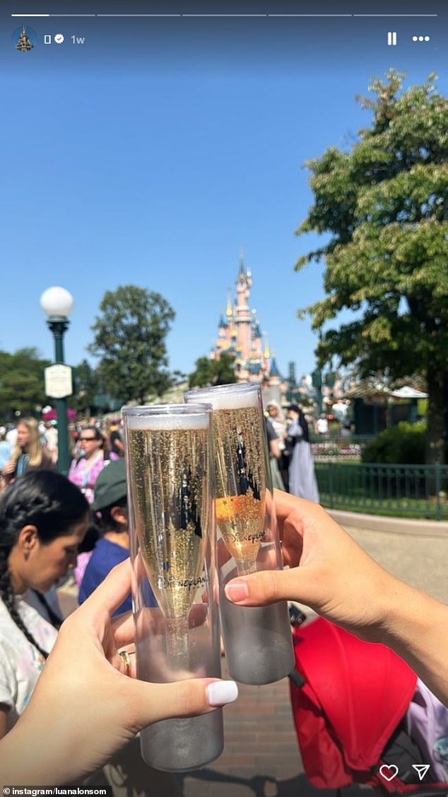 Paraguayan swimmer Luana Alonso clinks glasses of champagne at Euro Disneyland