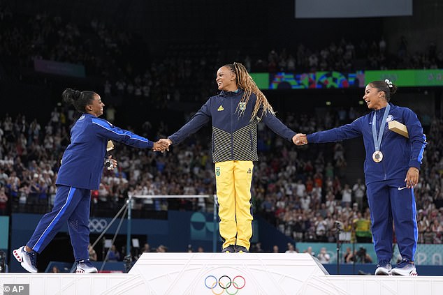 The trio held hands as they celebrated their success on the final day of gymnastics in Paris