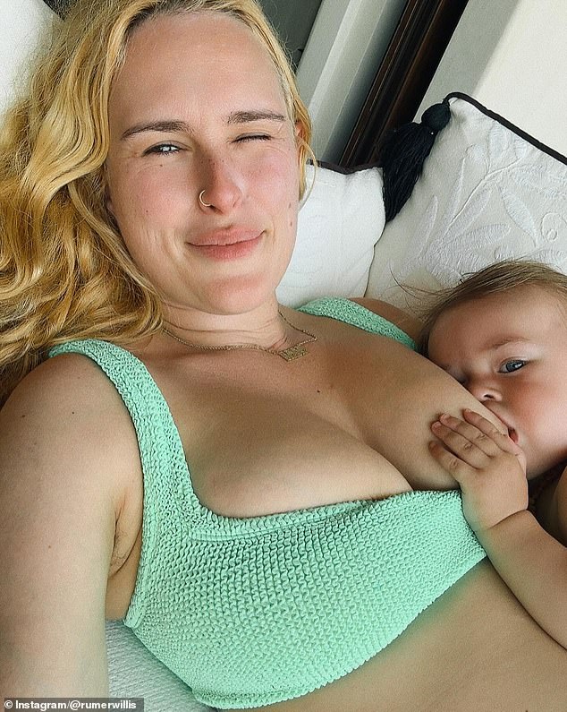 In the first photo of the photo carousel, the devoted mother wears a green bra top and casually breastfeeds her daughter. 