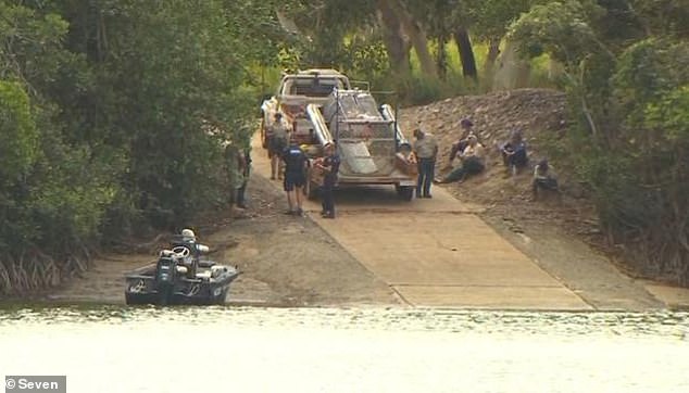 The 40-year-old man was attacked by a crocodile in front of his wife and children while fishing at the Annan River bridge, south of Cooktown (pictured is a baited crocodile trap placed in the water)